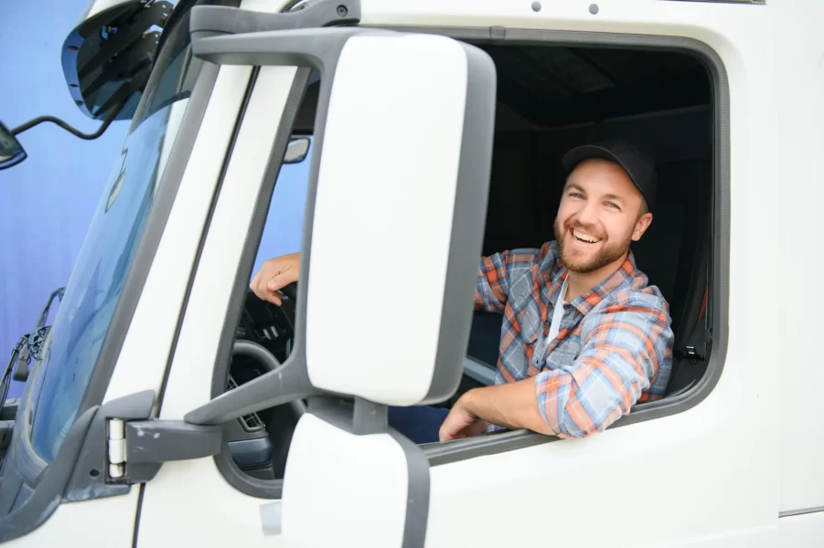 Close up of truck driver behind steering wheel. Copy space.